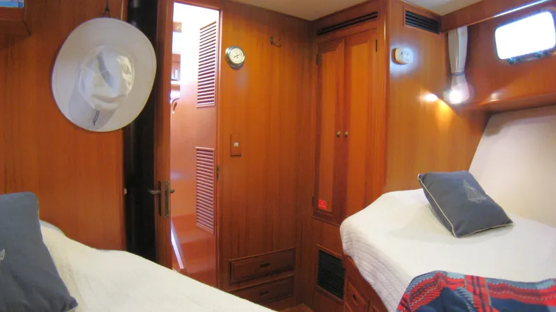 Slide: The Image of Interior of 2003 Ocean Alexander 423 Classicco yacht with wooden paneling and cozy bedding. - 33