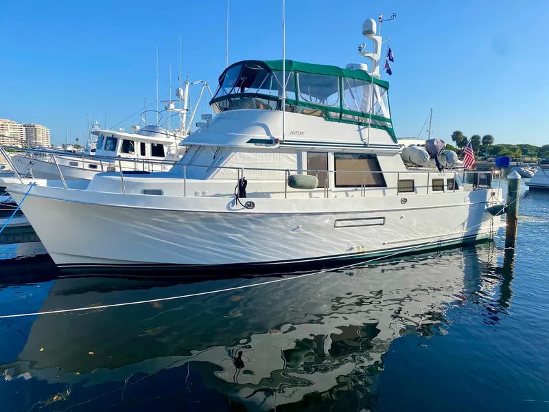 Slide: The Image of 2003 Ocean Alexander 423 Classicco yacht docked in a marina, reflecting on water. - 48