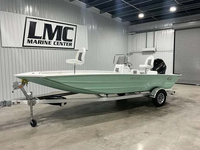 Slide: The Image of 2025 G3 Bay 20 boat cruising on a serene lake with lush green trees. - 1