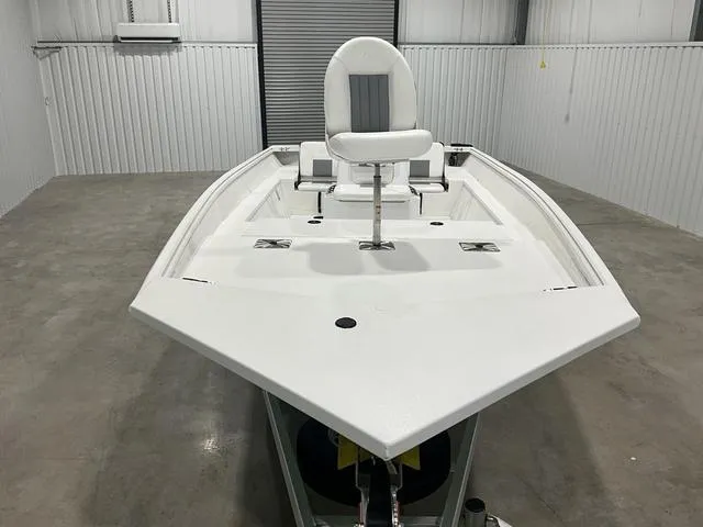 Slide: The Image of 2025 G3 Bay 20 boat in a garage, featuring a sleek white design and elevated seat. - 10