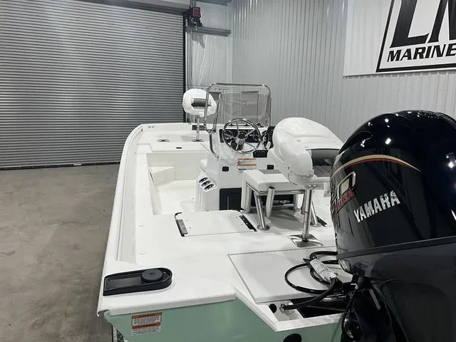 Slide: The Image of 2025 G3 Bay 20 boat with Yamaha engine in a garage setting. - 13