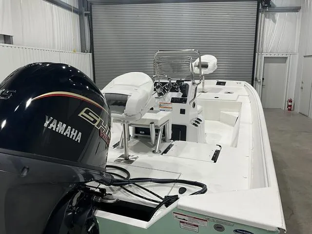 Slide: The Image of 2025 G3 Bay 20 boat with Yamaha engine in a garage setting. - 14