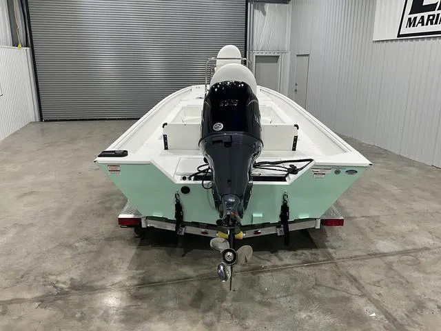 Slide: The Image of 2025 G3 Bay 20 boat with outboard motor in a garage. - 6