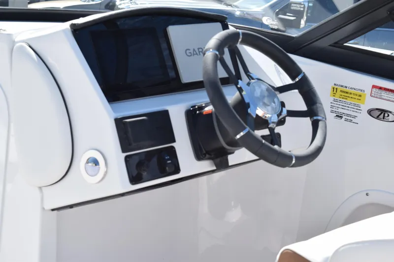 Slide: The Image of 2025 Stingray 211DC boat dashboard with steering wheel and Garmin navigation system. - 10
