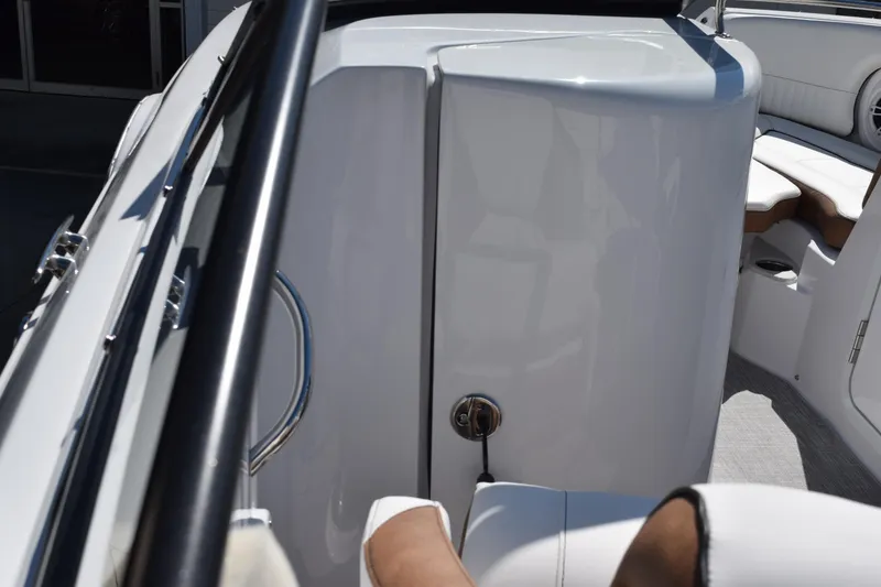 Slide: The Image of 2025 Stingray 211DC boat interior, featuring sleek white seating and modern design elements. - 12