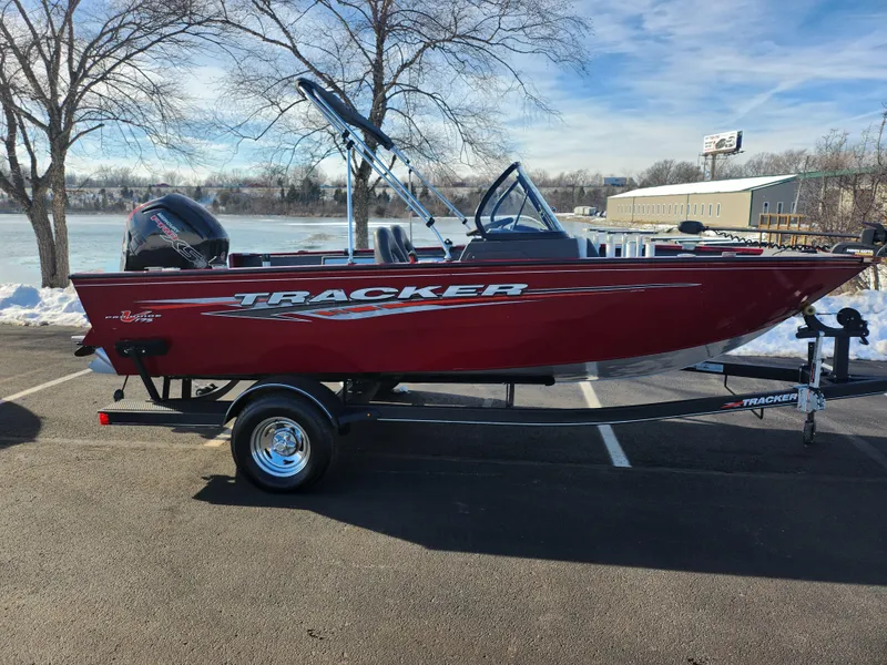 Slide: The Image of 2022 Tracker Pro Guide V-175 WT boat in a parking lot, red exterior, winter setting. - 10