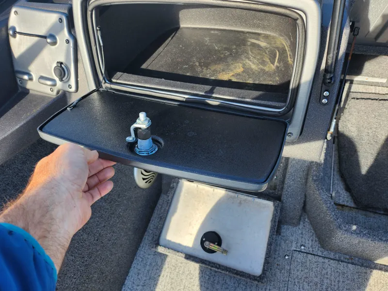 Slide: The Image of 2022 Tracker Pro Guide V-175 WT boat storage compartment with open lid and hand. - 16