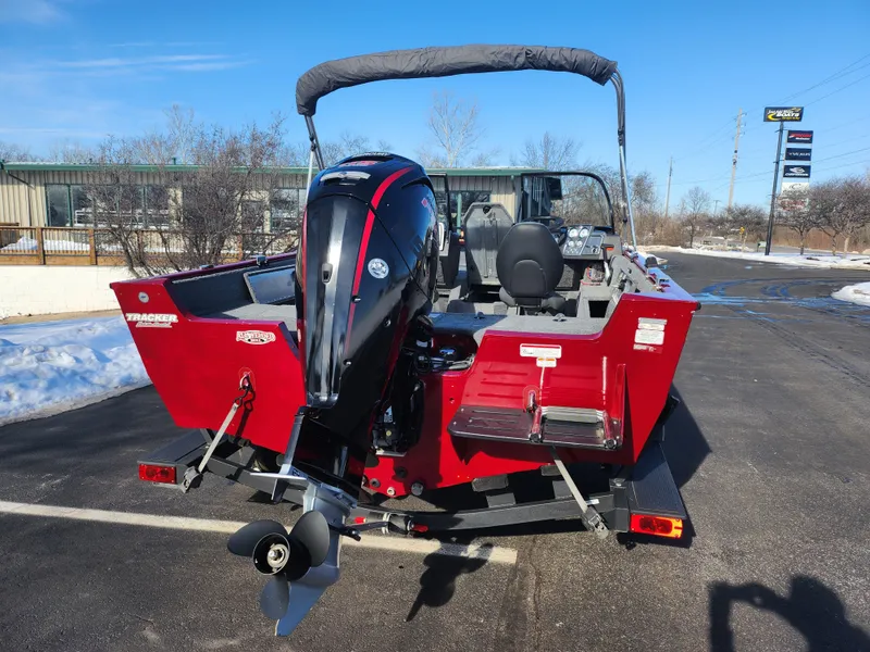 Slide: The Image of 2022 Tracker Pro Guide V-175 WT boat with outboard motor, parked on a snowy lot. - 2