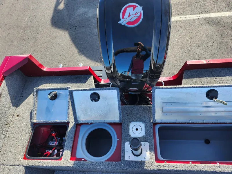 Slide: The Image of 2022 Tracker Pro Guide V-175 WT boat interior with storage compartments and motor. - 23