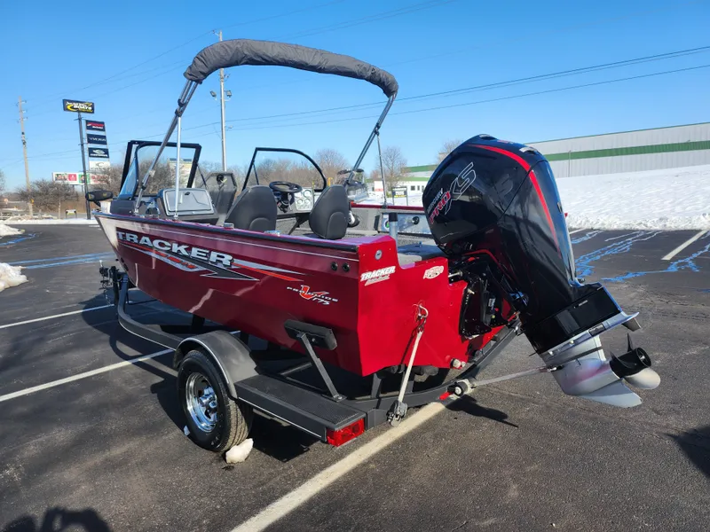 Slide: The Image of 2022 Tracker Pro Guide V-175 WT boat with outboard motor in a parking lot. - 3