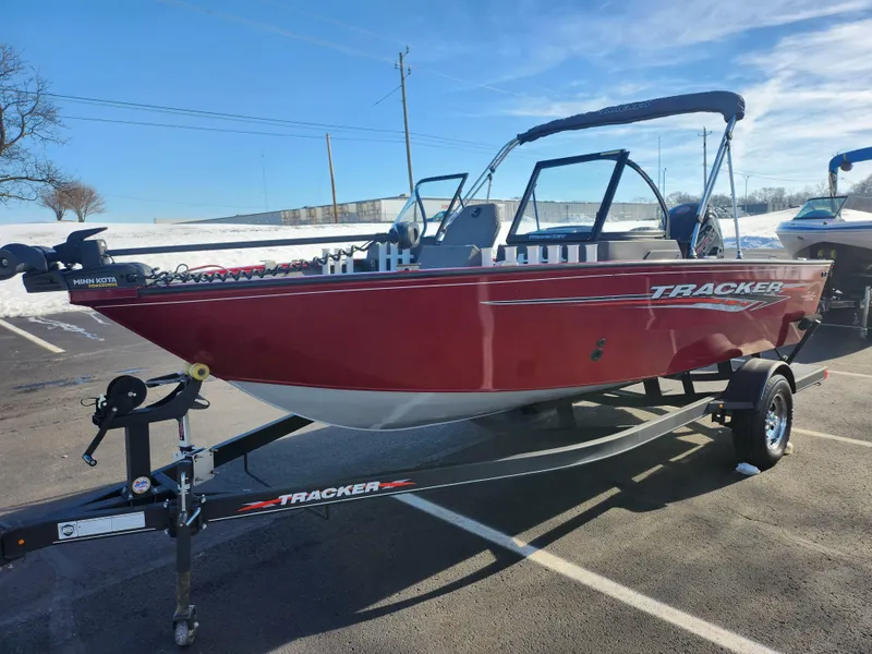 Slide: The Image of 2022 Tracker Pro Guide V-175 WT boat in a parking lot, red exterior, on a trailer. - 5