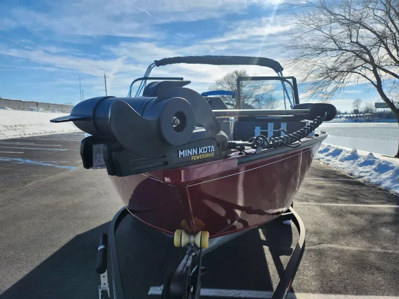 Slide: The Image of 2022 Tracker Pro Guide V-175 WT boat with Minn Kota motor in snowy parking lot. - 7
