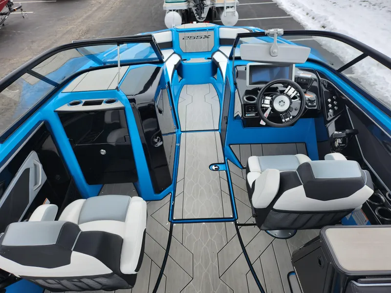 Slide: The Image of 2022 Yamaha Boats 255XD interior with modern dashboard and seating. - 10