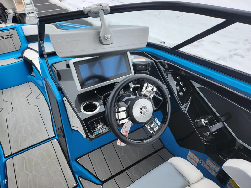 Slide: The Image of 2022 Yamaha Boats 255XD cockpit with modern steering and touchscreen display. - 11