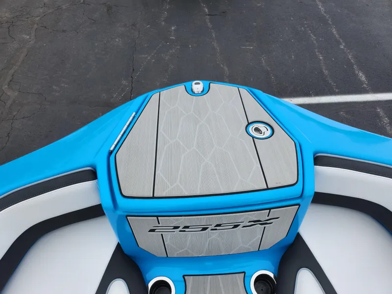 Slide: The Image of 2022 Yamaha Boats 255XD, blue and gray deck, sleek design. - 16