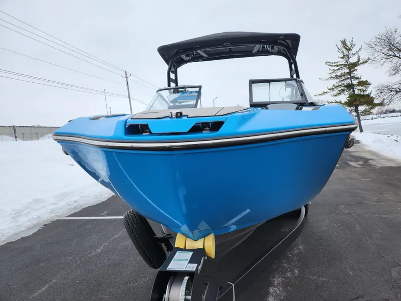 Slide: The Image of 2022 Yamaha Boats 255XD in blue, parked on a snowy road. - 6