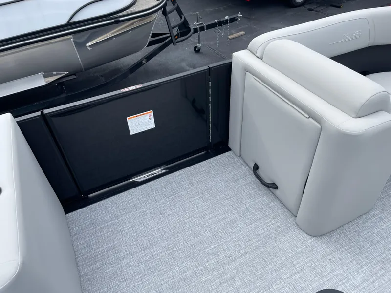 Slide: The Image of 2025 Harris Cruiser 210 interior with gray seating and carpeted flooring. - 10