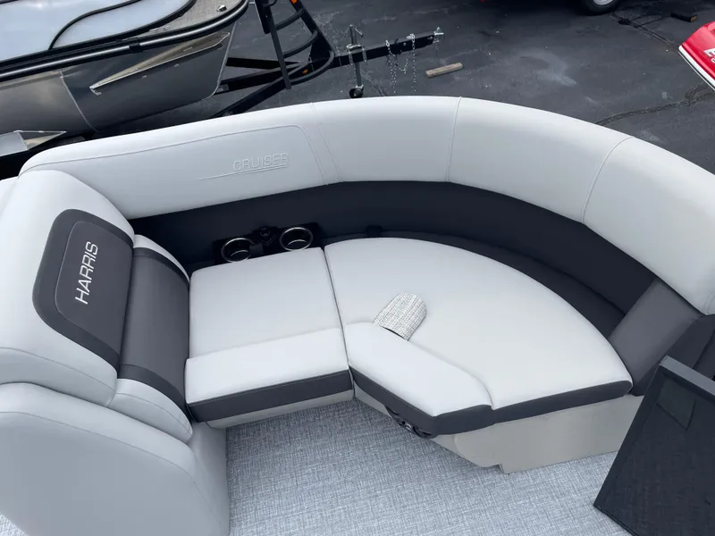 Slide: The Image of 2025 Harris Cruiser 210 boat interior with gray seating and cup holders. - 11