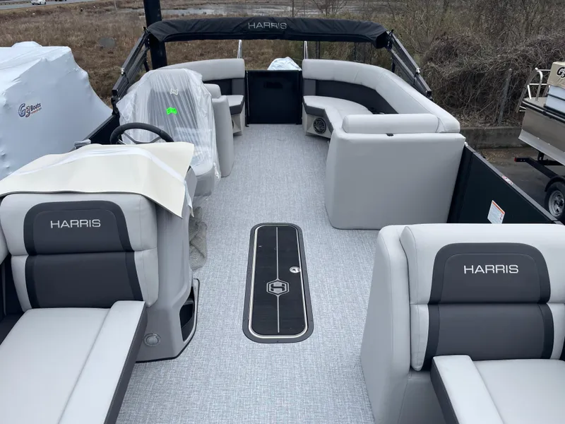 Slide: The Image of 2025 Harris Cruiser 210 pontoon boat interior with gray seating and steering console. - 4
