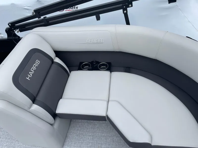 Slide: The Image of 2025 Harris Cruiser 210 boat seating with cup holders, featuring gray and white upholstery. - 7