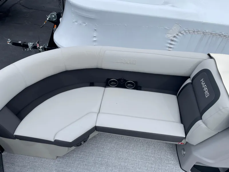 Slide: The Image of 2025 Harris Cruiser 210 boat seating with gray and white upholstery. - 8