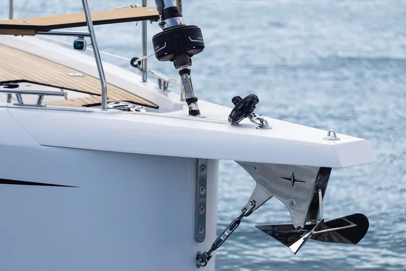 Slide: The Image of 2025 Bavaria C46 yacht bow with anchor, sleek design on calm water. - 3