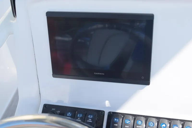 Slide: The Image of 2025 Stingray 216CC dashboard with Garmin display and control panel. - 10