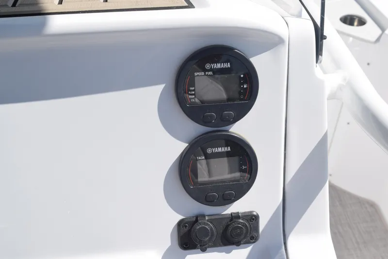 Slide: The Image of 2025 Stingray 216CC boat dashboard with Yamaha gauges and controls. - 11