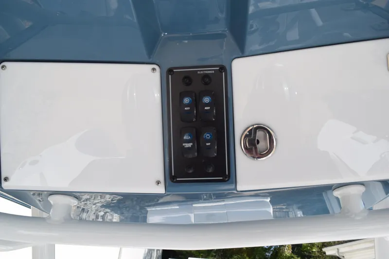 Slide: The Image of 2025 Stingray 216CC boat dashboard with control panel and key slot. - 12