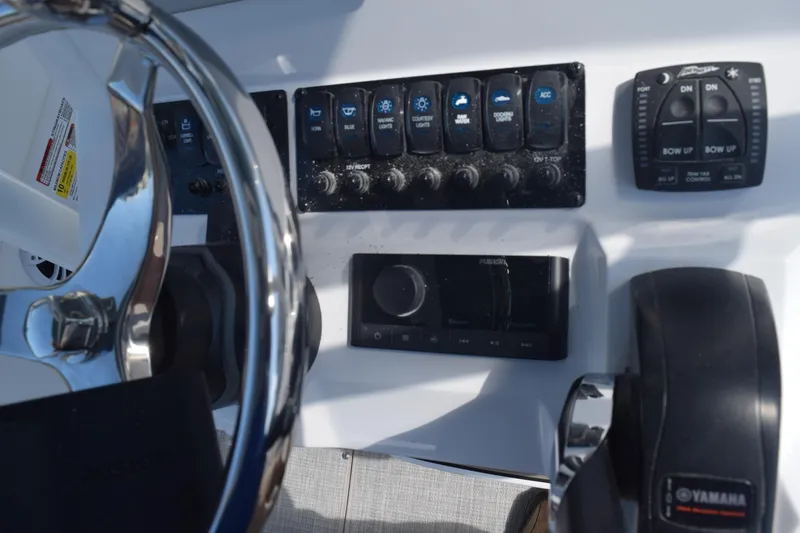 Slide: The Image of 2025 Stingray 216CC boat dashboard with controls and steering wheel. - 13