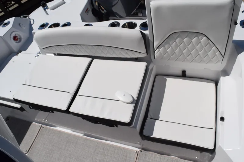 Slide: The Image of 2025 Stingray 216CC boat seating with white cushioned upholstery and diamond stitching. - 17