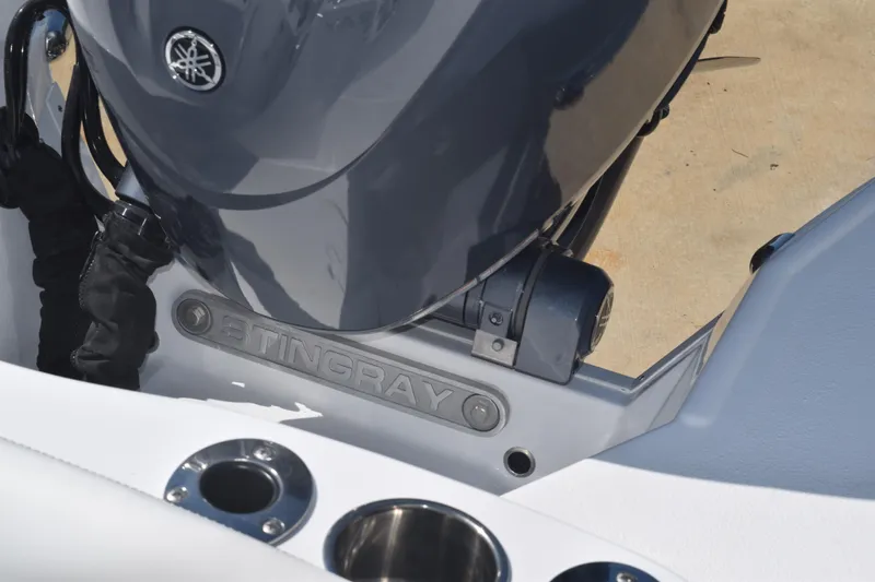 Slide: The Image of 2025 Stingray 216CC boat engine detail with cup holders. - 18