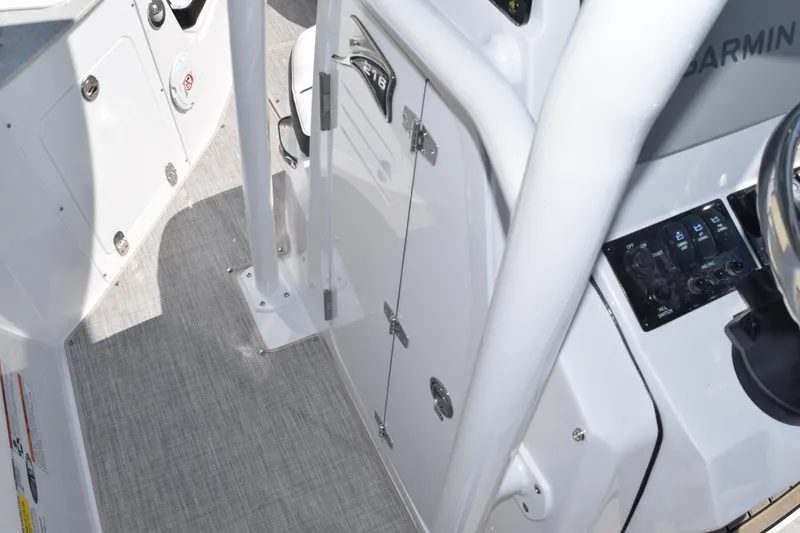 Slide: The Image of 2025 Stingray 216CC boat interior with control panel and storage compartment. - 20