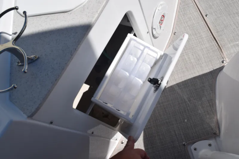 Slide: The Image of Stingray 216CC 2025 boat storage compartment with open hatch and interior view. - 22