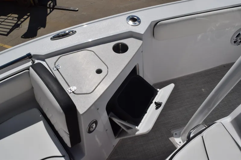 Slide: The Image of 2025 Stingray 216CC boat interior with storage compartment and cup holder. - 24