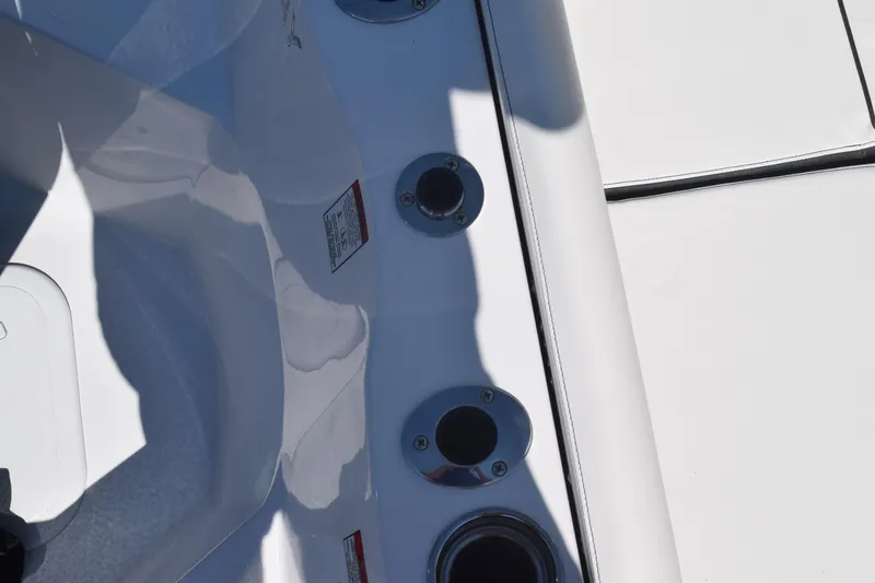 Slide: The Image of 2025 Stingray 216CC boat deck with cup holders and sleek white finish. - 34
