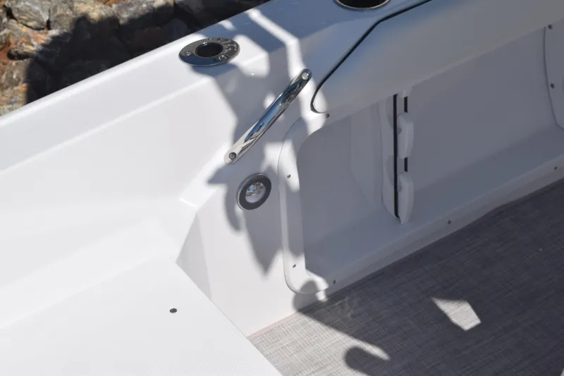 Slide: The Image of 2025 Stingray 216CC boat interior detail with white finish and stainless steel fixtures. - 36