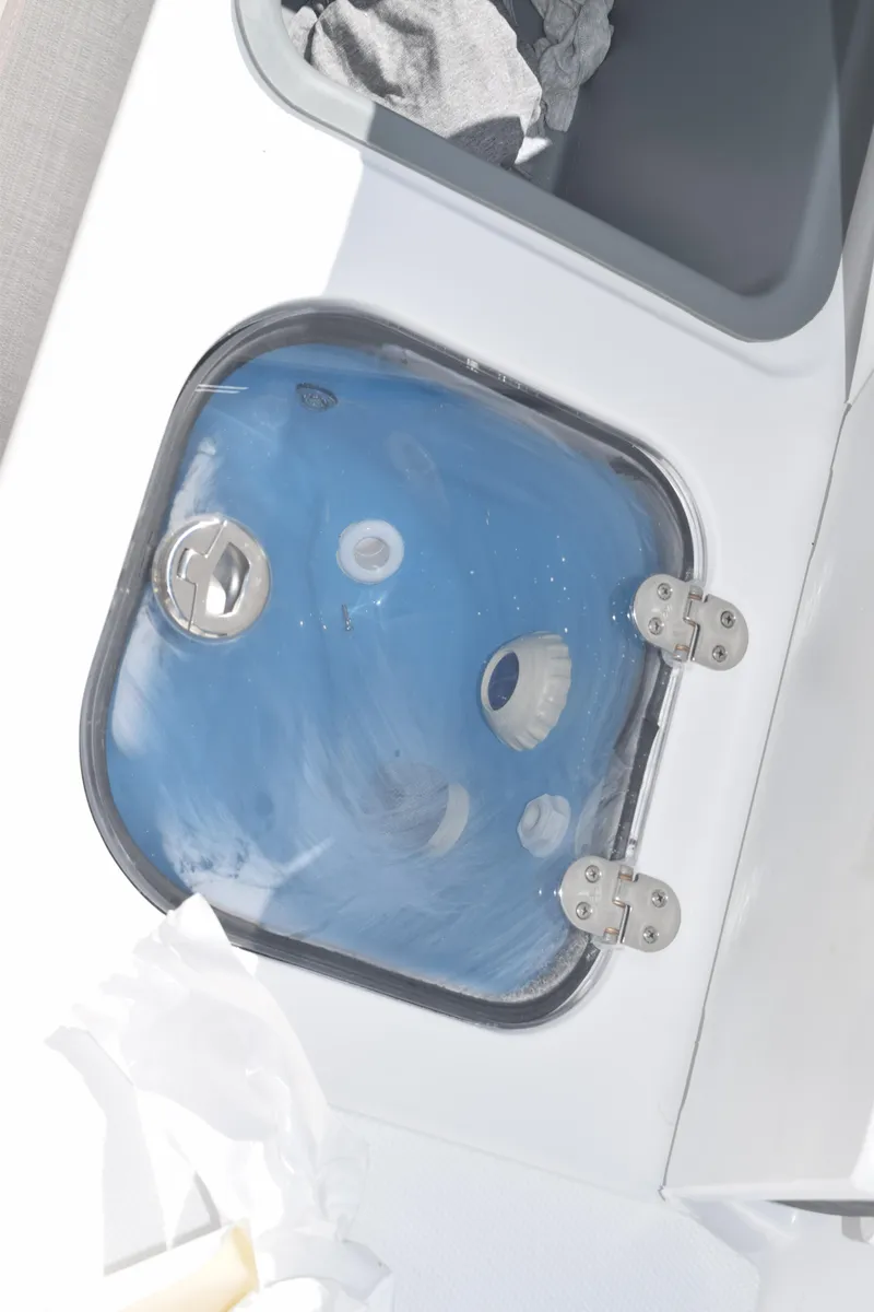 Slide: The Image of 2025 Stingray 216CC boat compartment with blue interior and metal hinges. - 38