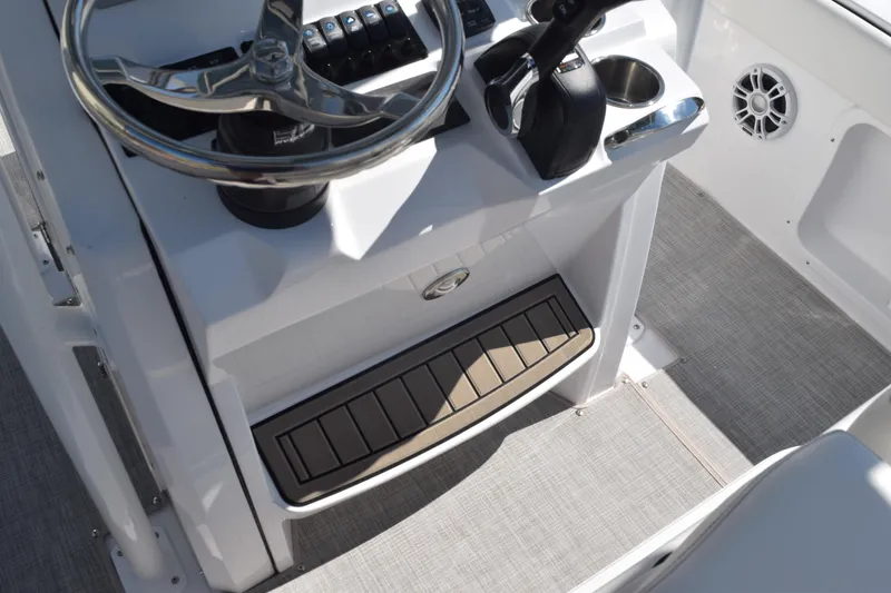 Slide: The Image of 2025 Stingray 216CC boat console with steering wheel and controls, featuring modern design. - 41