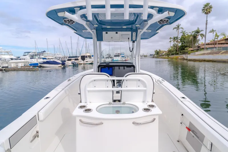 Slide: The Image of 2020 Seapro 25 DLX boat docked in a marina with clear skies. - 11