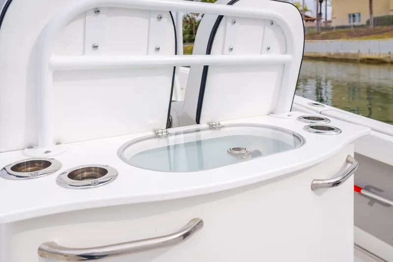 Slide: The Image of 2020 Seapro 25 DLX boat with sleek white console and stainless steel accents. - 12