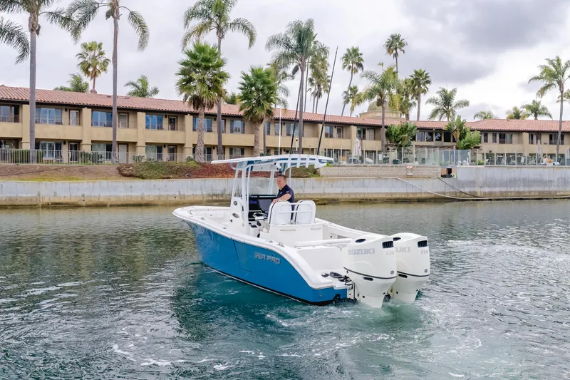 Slide: The Image of 2020 Seapro 25 DLX boat cruising near waterfront homes with palm trees. - 6