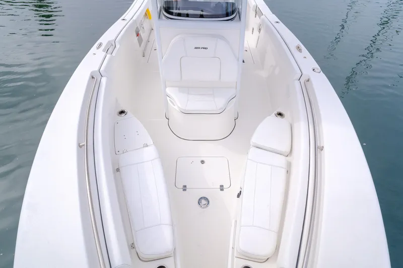 Slide: The Image of 2020 Seapro 25 DLX boat interior with white seating and sleek design on calm water. - 8