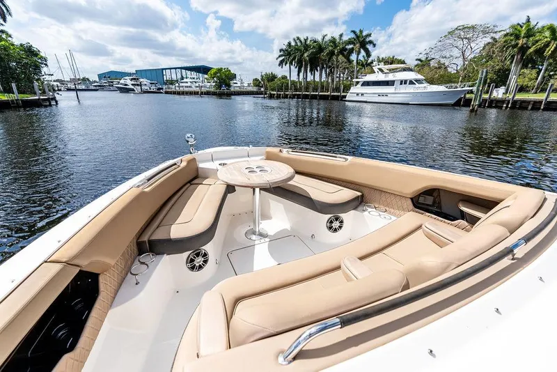 Slide: The Image of 2019 Sea Ray SLX 400 OB boat with luxurious seating on a scenic waterfront. - 21