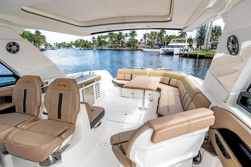 Slide: The Image of 2019 Sea Ray SLX 400 OB boat interior with luxurious seating and waterfront view. - 34
