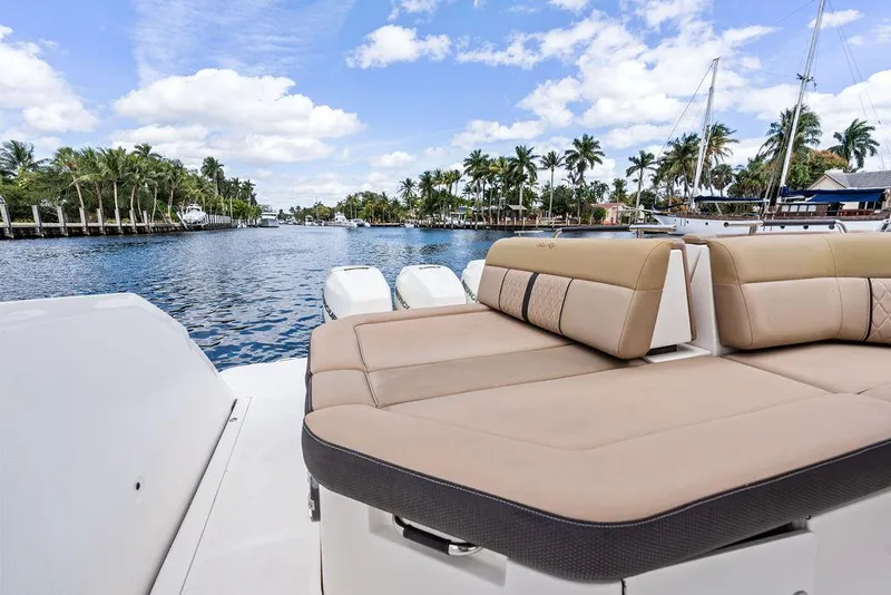 Slide: The Image of 2019 Sea Ray SLX 400 OB boat with luxurious seating, cruising on a scenic waterway. - 36