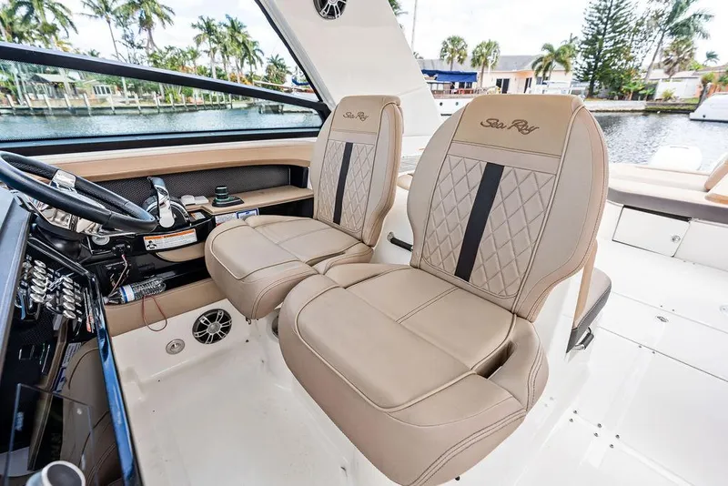 Slide: The Image of 2019 Sea Ray SLX 400 OB interior with luxurious beige seating and modern dashboard. - 38