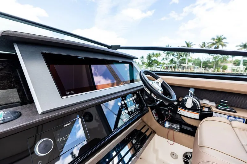 Slide: The Image of 2019 Sea Ray SLX 400 OB helm with modern controls and luxurious seating. - 39