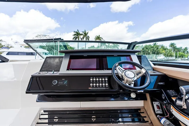 Slide: The Image of 2019 Sea Ray SLX 400 OB helm with modern controls and navigation screens. - 41