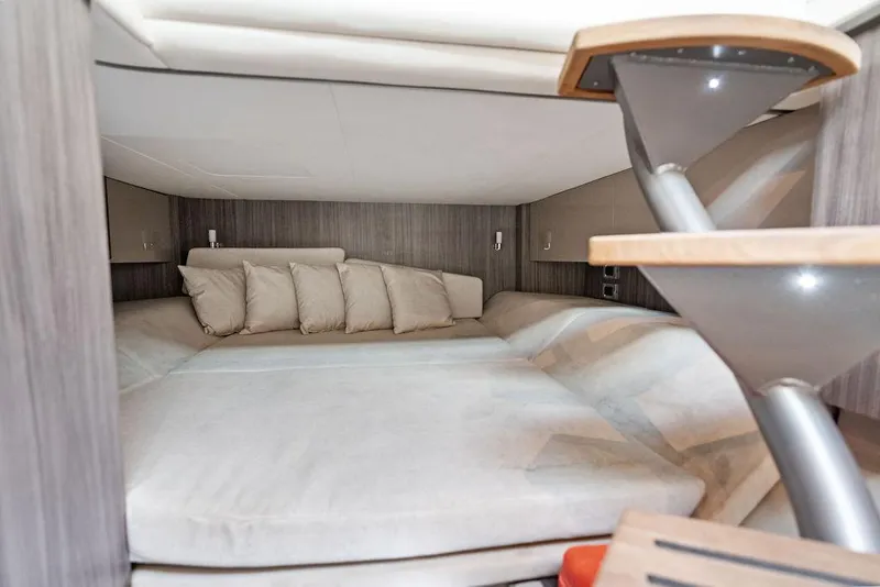 Slide: The Image of 2019 Sea Ray SLX 400 OB cabin interior with cozy bedding and modern design. - 48